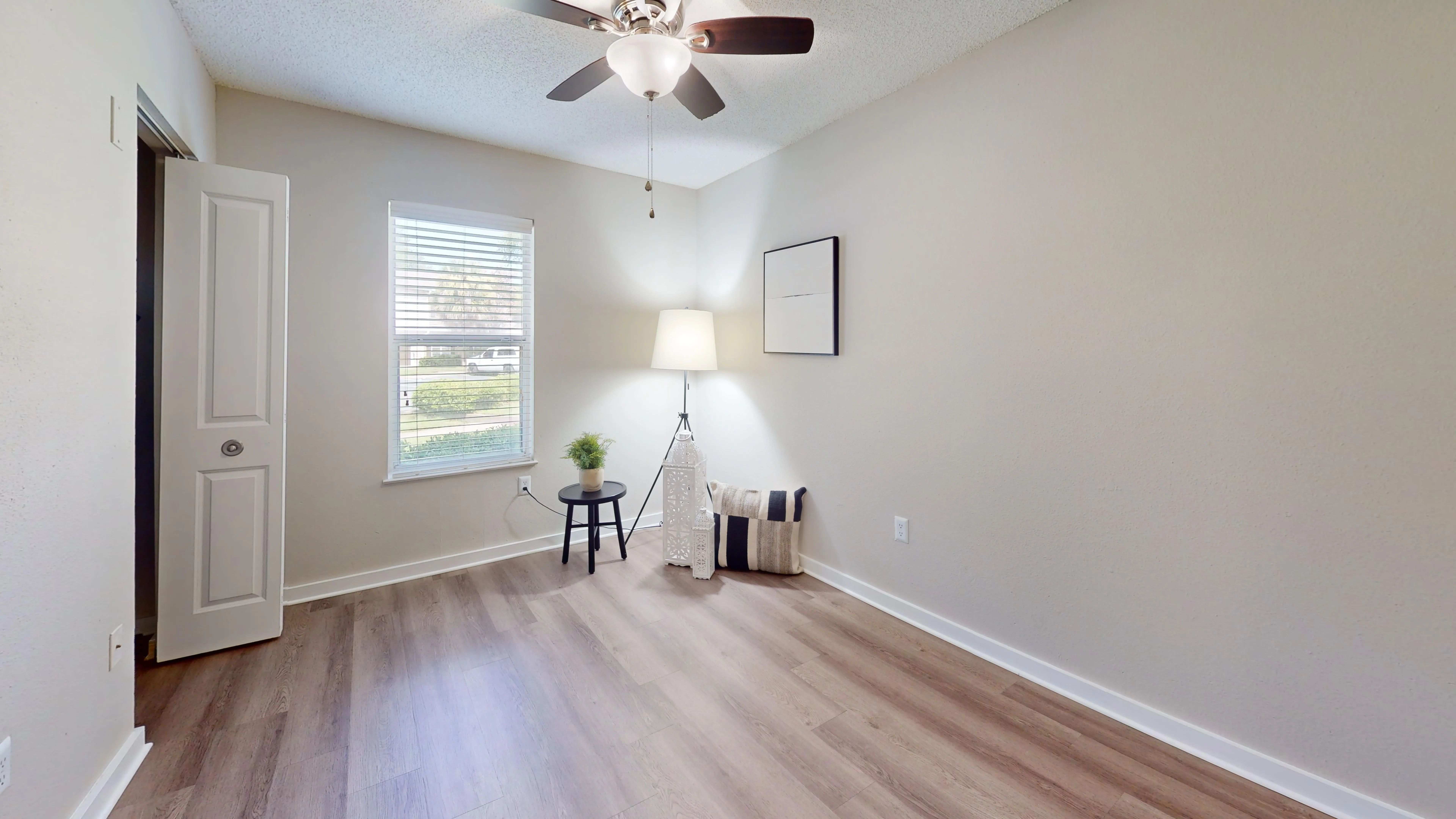 Experience comfort in the Jekyll guest bedroom featuring a lighted ceiling fan and thoughtfully designed closet space for your convenience.