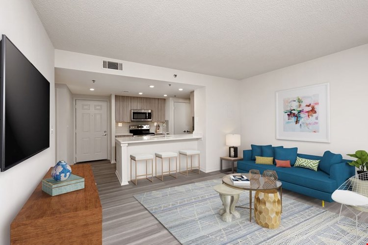 Renovated Package II kitchen, living, and dining areas with hard surface flooring