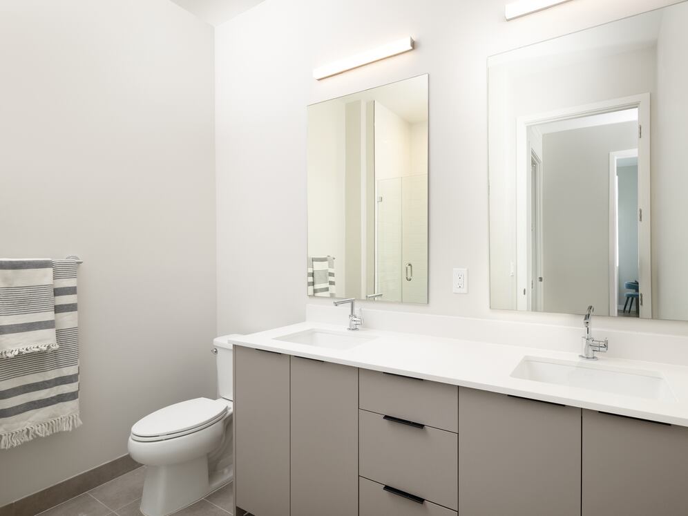 Upgrade Collection II primary bath with double-sink vanity, white quartz countertops, and standing shower
