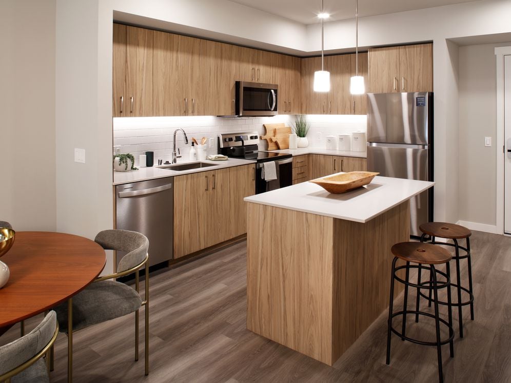 Design Collection II Kitchen with oak cabinetry, white quartz countertops, and white tile backsplash