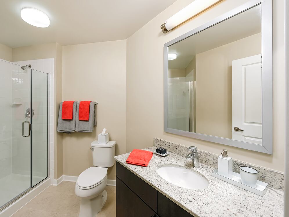Classic Package II townhome bath with white speckled granite countertop and espresso cabinetry