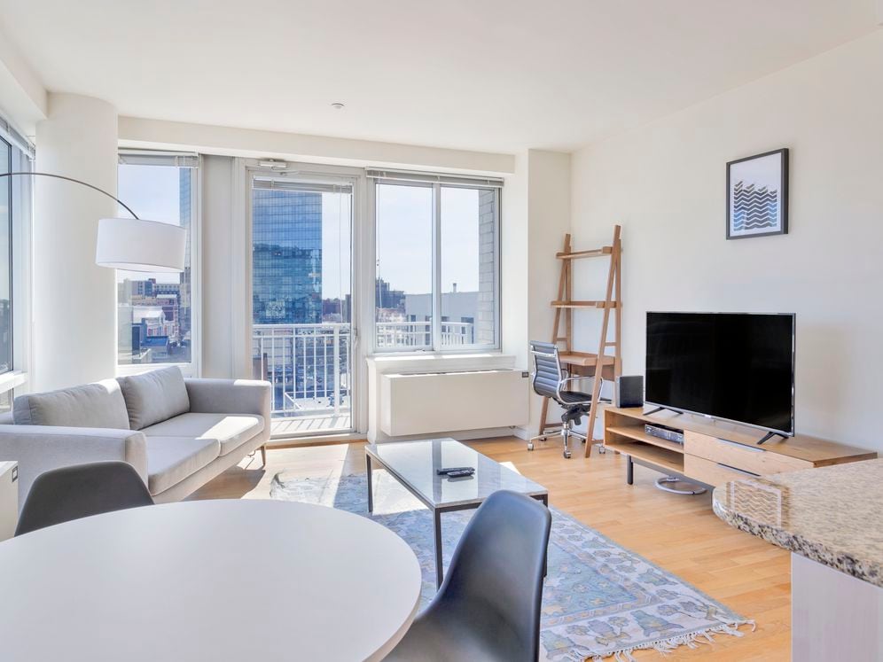 Furnished+ apartment homes come outfitted with a sofa, side chair, side table, coffee table, TV stand and 50" Television (Representative Image – exact items and style of furnishings may vary)