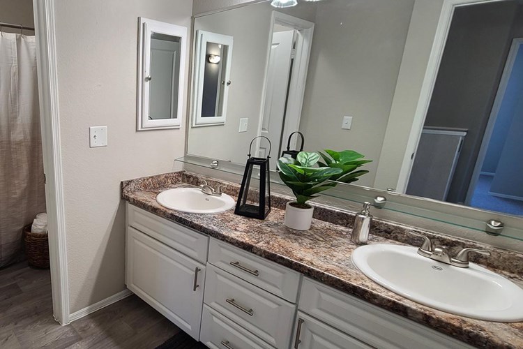 Our bathrooms feature granite-style countertops and tons of storage space. 