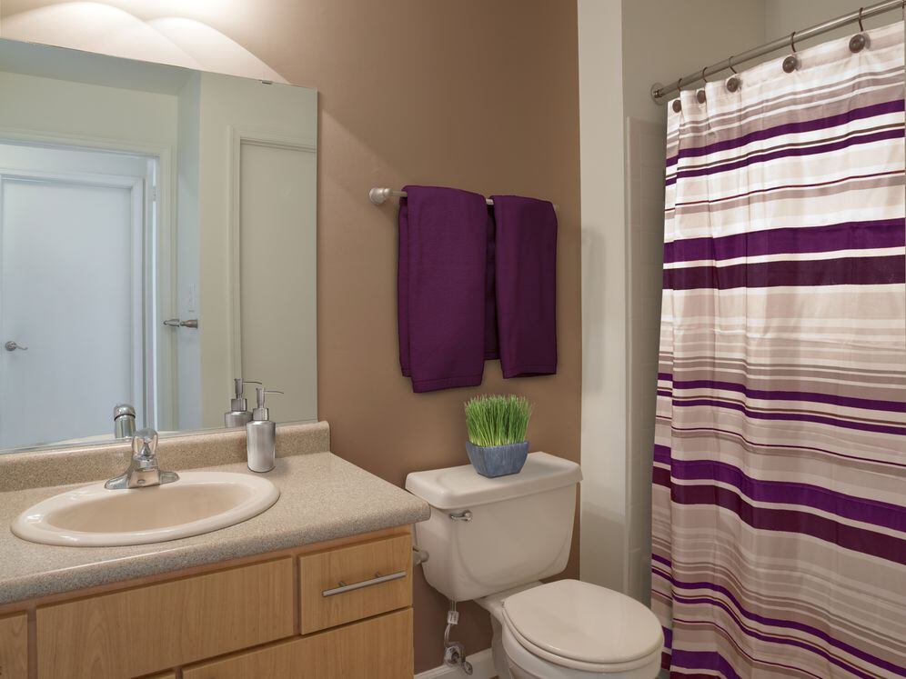 Classic Package bath with grey laminate countertops, oak cabinetry, and hard surface flooring