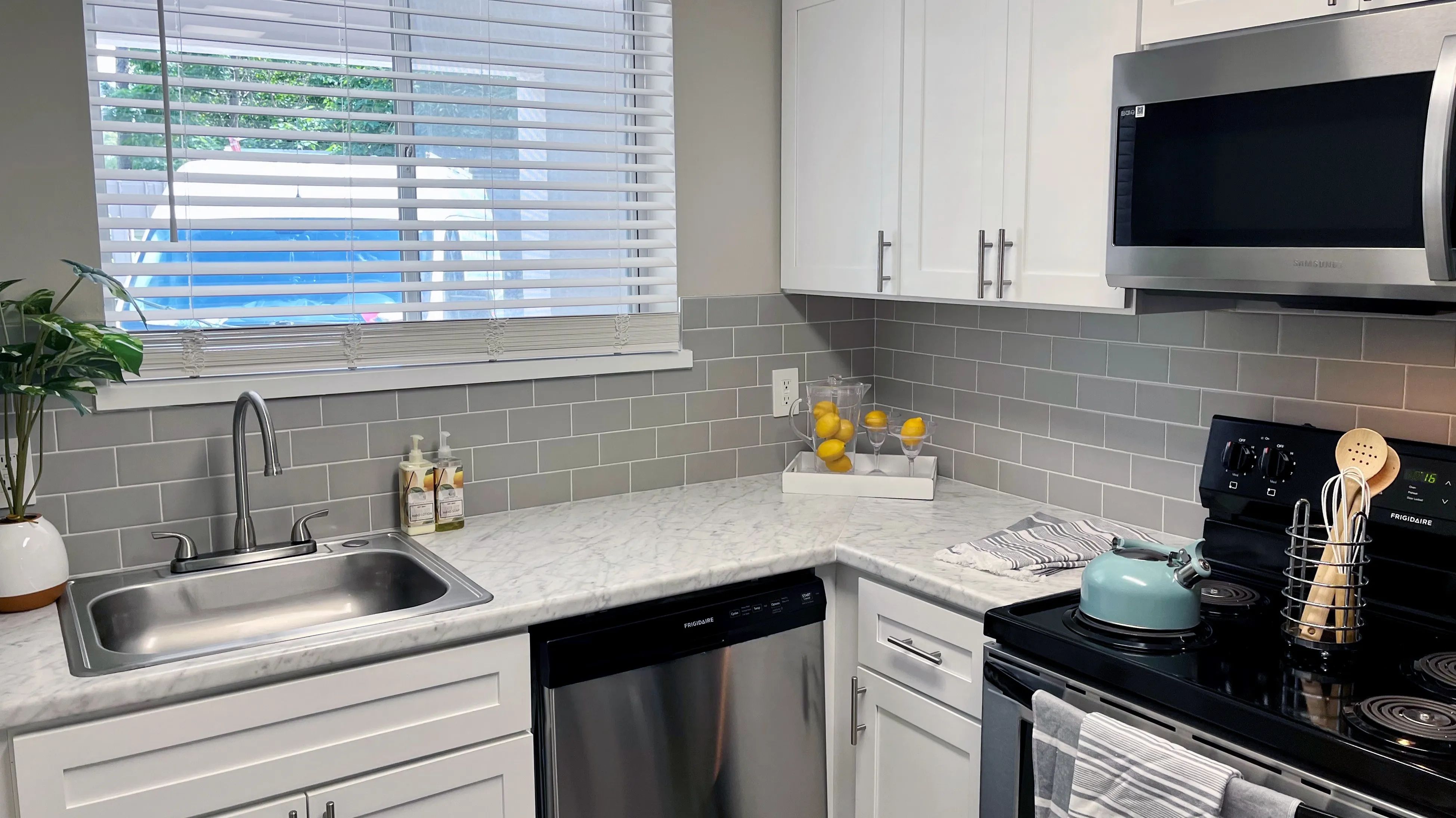 Renovated kitchen options include modern finishes with white cabinetry and subway tile backsplash for a chic living experience.