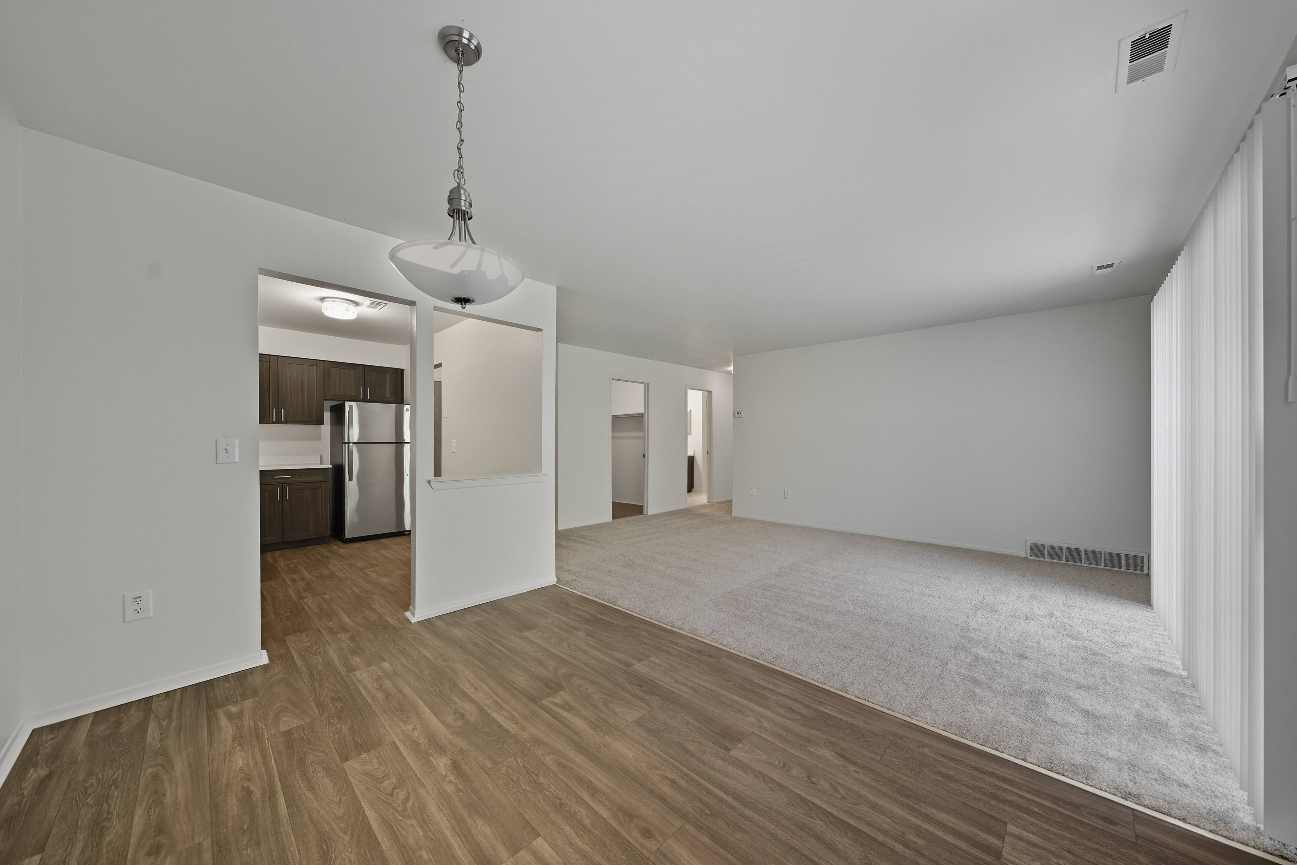 Open Living/Dining Room with natural light at Franklin River Apartments in Southfield, MI