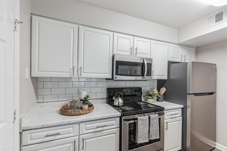 Kitchens feature stainless steel appliances.