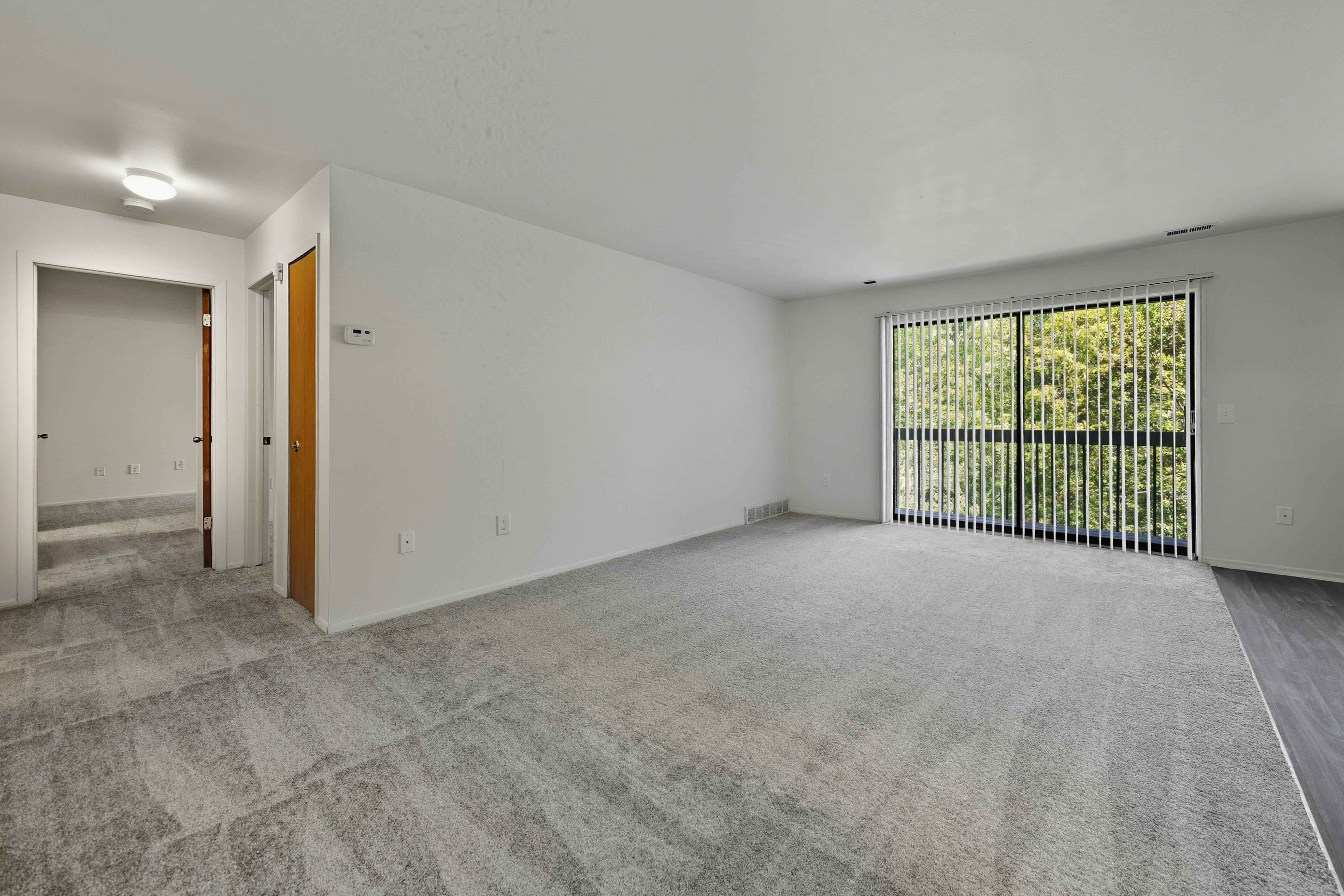 Open Living Room with natural light at Franklin River Apartments in Southfield, MIng Room with natural light at Franklin River Apartments in Southfield, MI