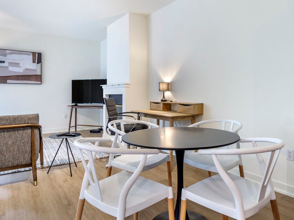 Furnished+ apartment homes include a dining set (Representative Image – exact items and style of furnishings may vary)