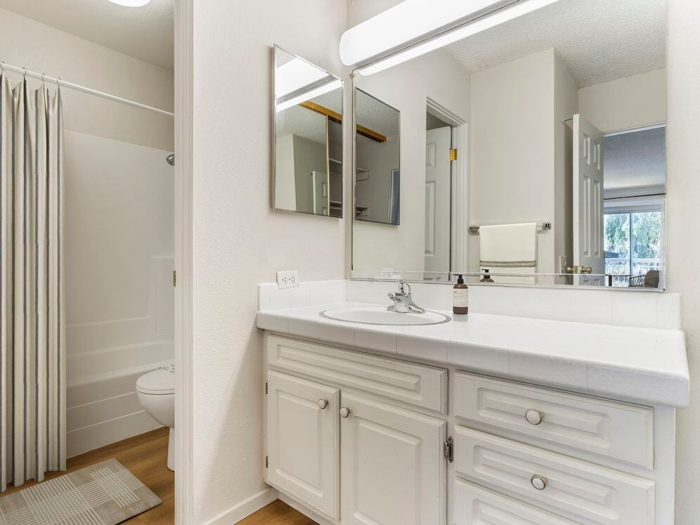 Classic Package II bath with white tile countertop, white cabinetry, and hard surface flooring