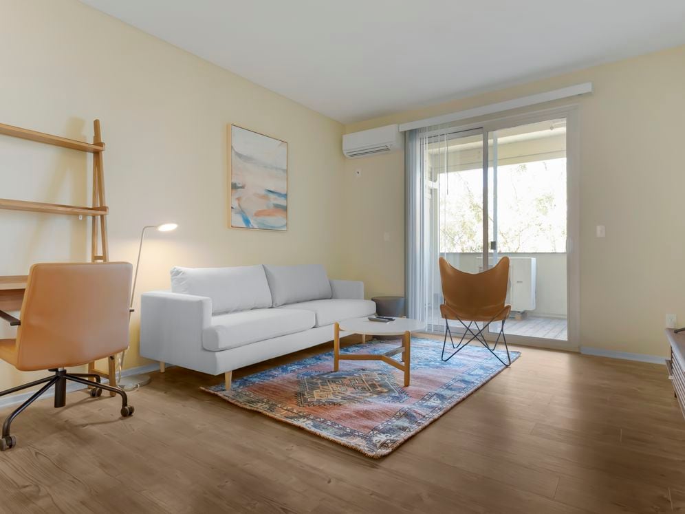 Furnished+ apartment homes come outfitted with a sofa, side chair, side table, coffee table, TV stand and 50" Television (Representative Image – exact items and style of furnishings may vary)