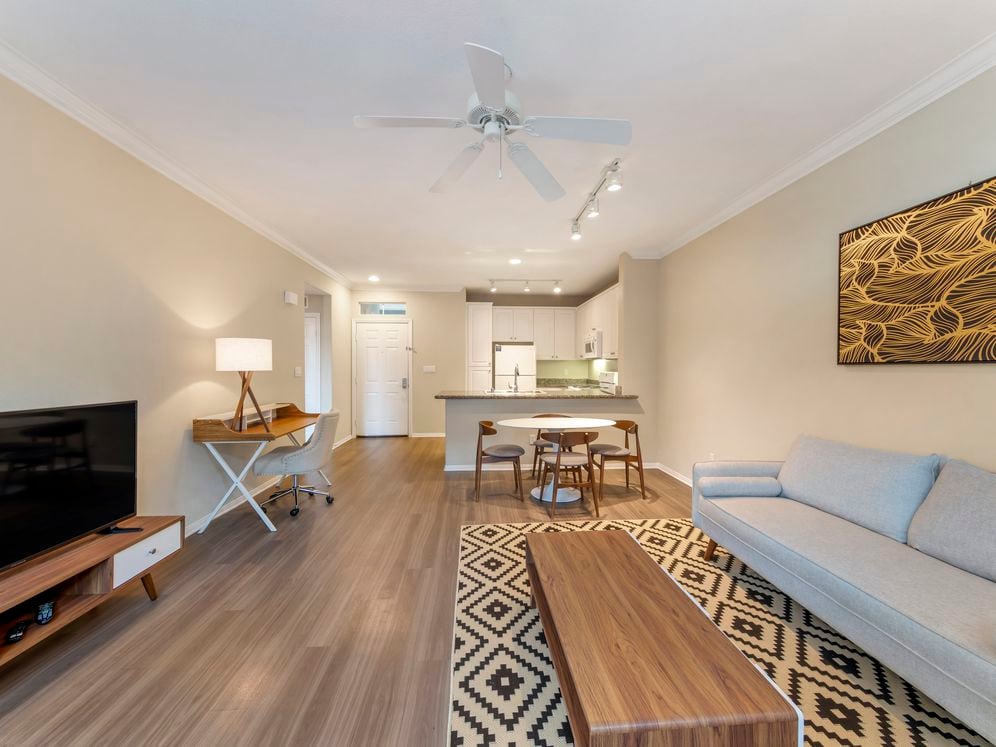 Furnished+ apartment homes come outfitted with a sofa, side chair, side table, coffee table, TV stand and 50" Television (Representative Image – exact items and style of furnishings may vary)