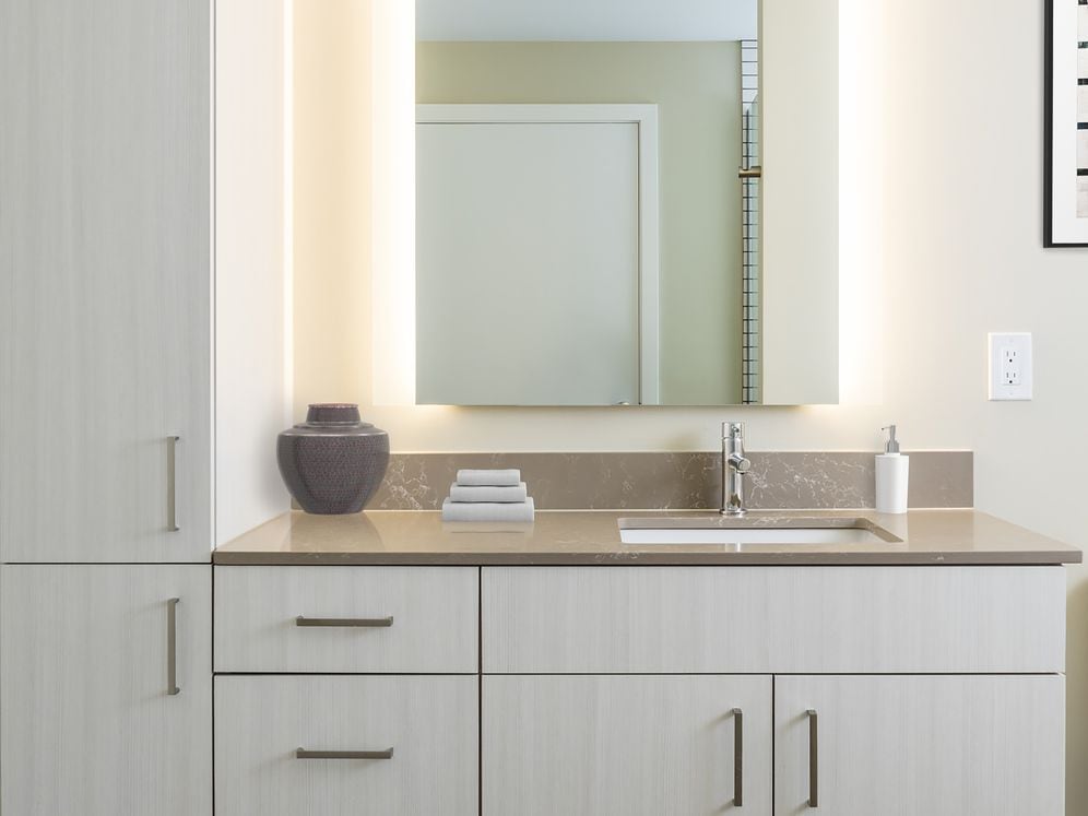 Scheme I bath with white cabinetry, quartz countertop, and hard surface flooring.