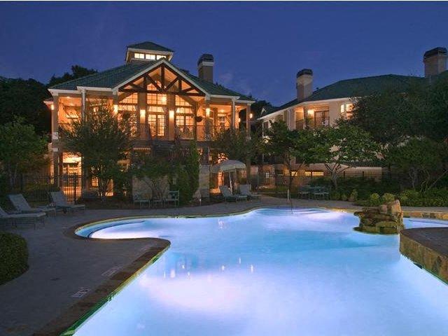 Nighttime pool view with clubhouse in the background