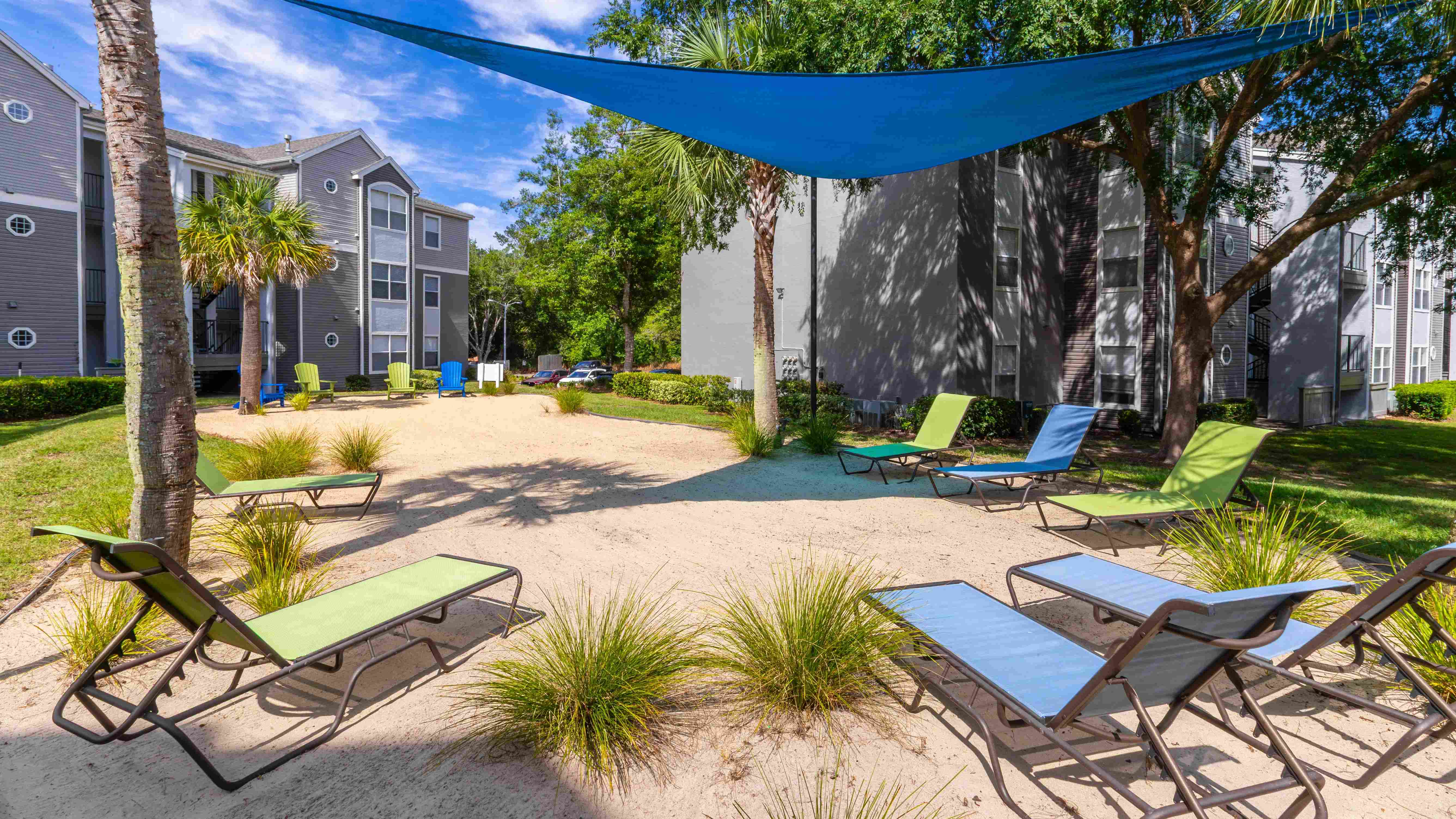 Kick back under the shade and feel the sand between your toes at The Enclave's private beach area.