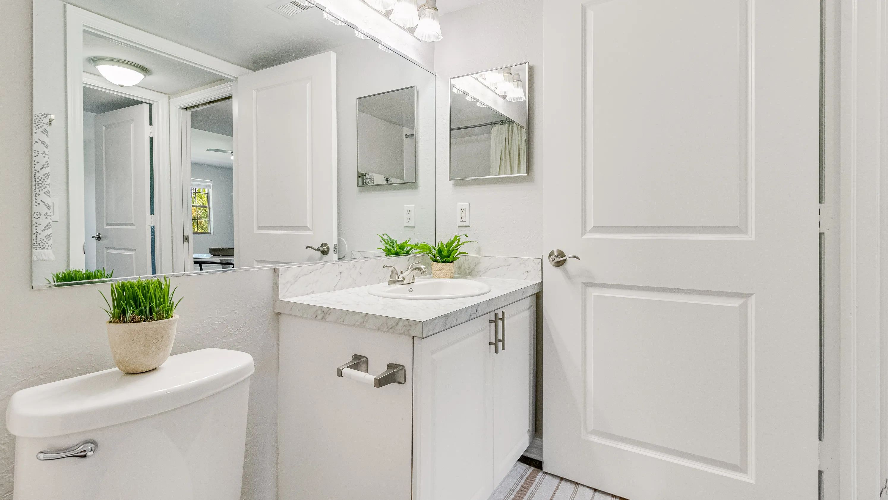 Check out our renovated bathrooms with large mirror and extra storage!