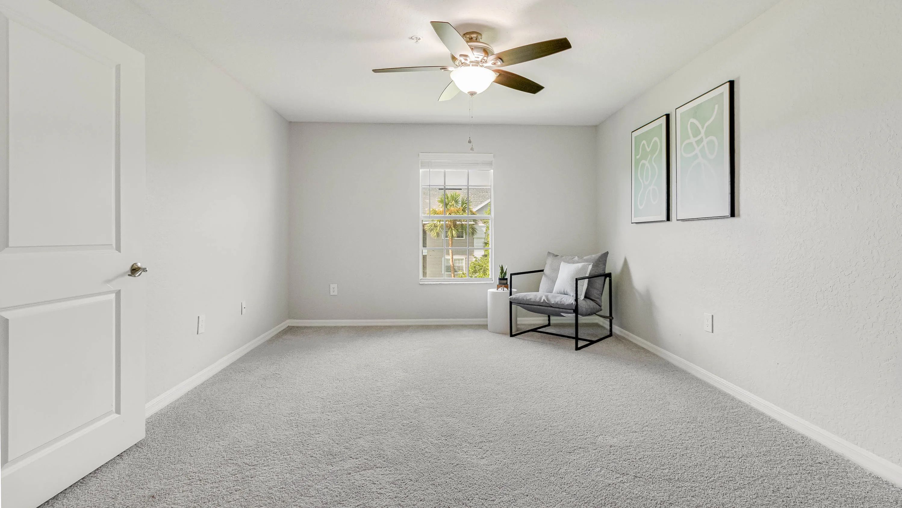 Indulge in serene bedroom luxury featuring expansive windows, plush carpeting, and a ceiling fan for peaceful nights. 