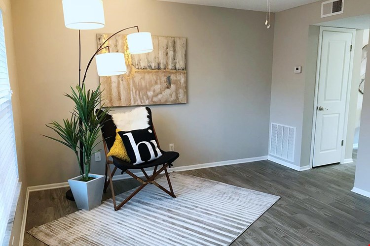 Spacious, open living room featuring wood-style flooring, and a ceiling fan.