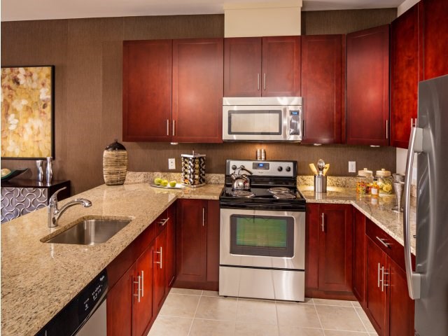 A chef's kitchen complete with granite countertops, 42" cabinetry and stainless steel appliances.