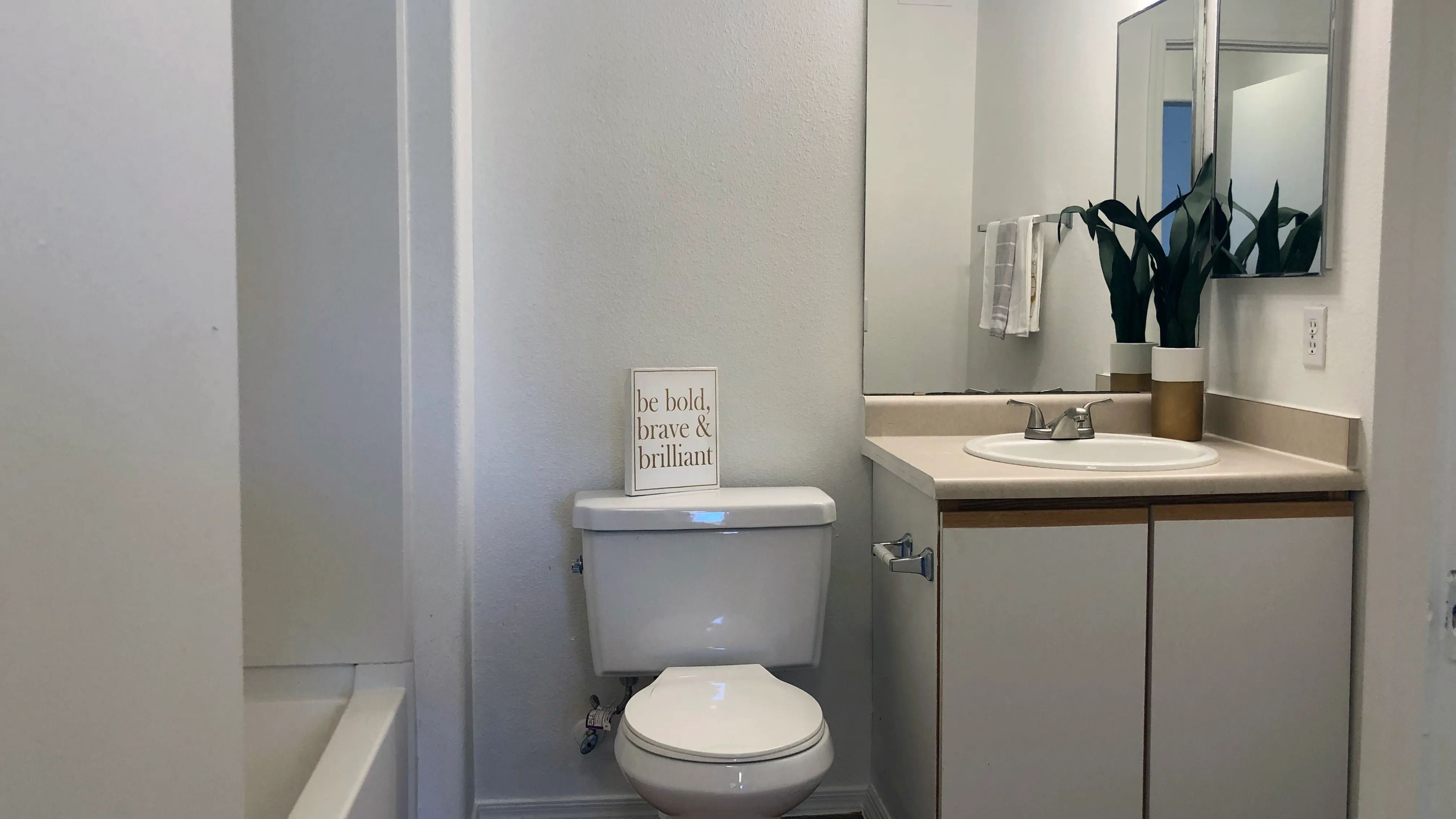 Step into classic-style bathrooms with wood-style flooring, creating an everyday oasis of comfort and privacy.