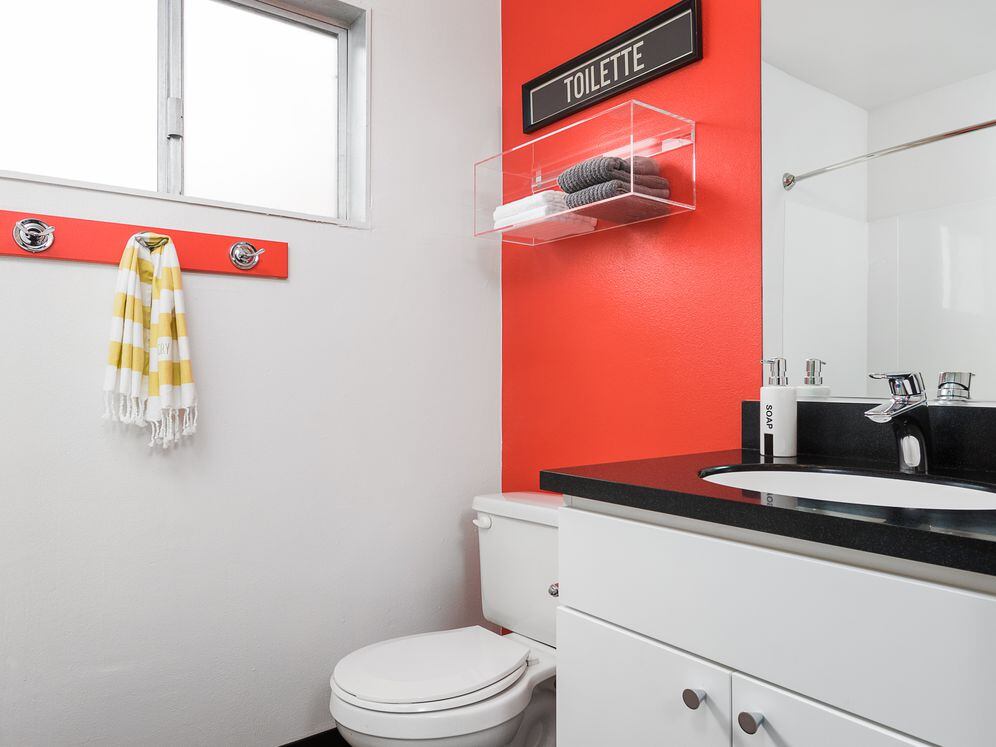 Classic Package II bath with black laminate countertops, white cabinetry, and hard surface flooring