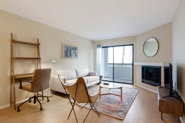 Furnished+ apartment homes come outfitted with a sofa, side chair, side table, coffee table, TV stand and 50" Television (Representative Image – exact items and style of furnishings may vary)