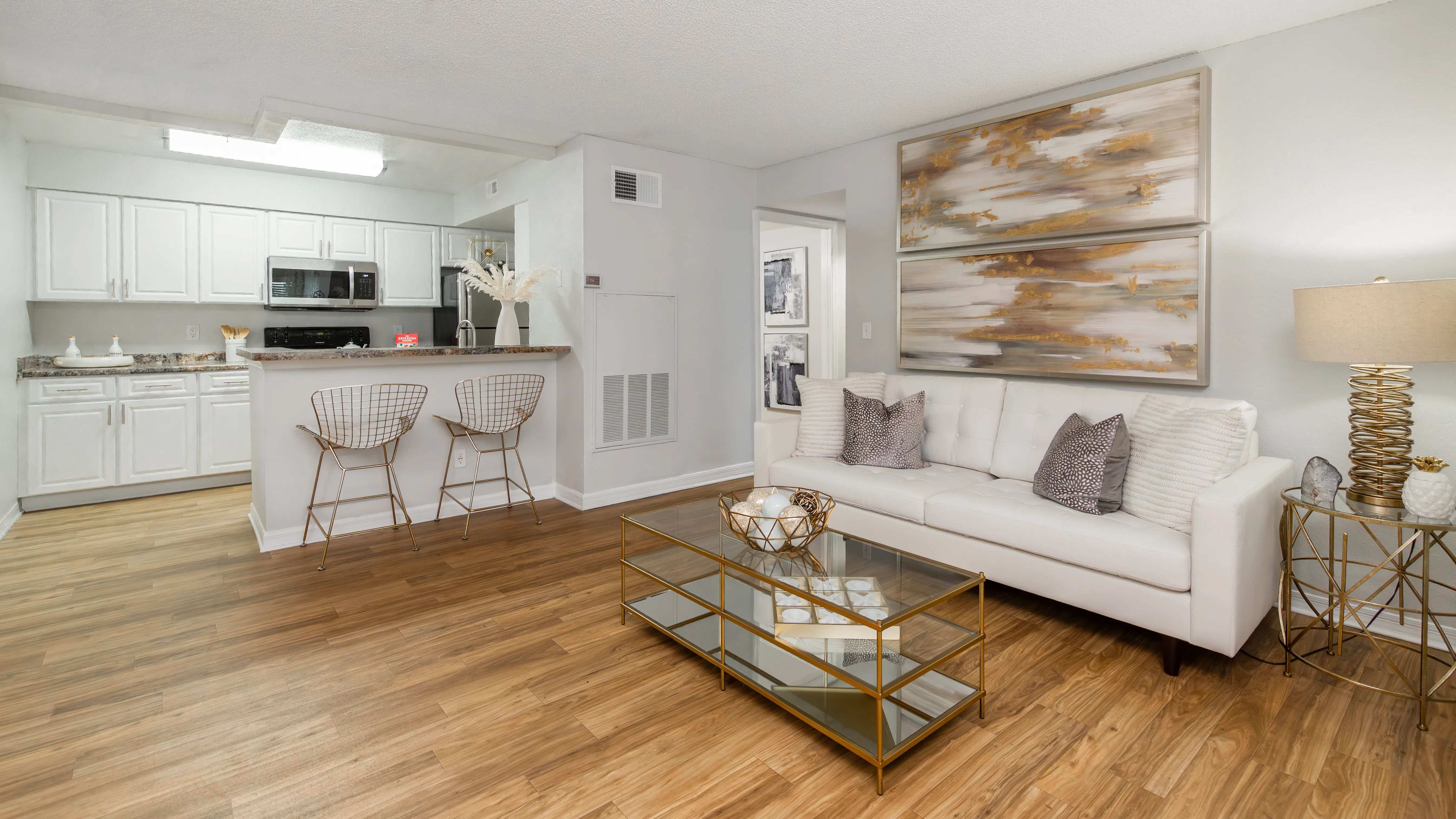 Enjoy effortless entertaining with this open layout, featuring wood-style flooring and soft neutral tones.
