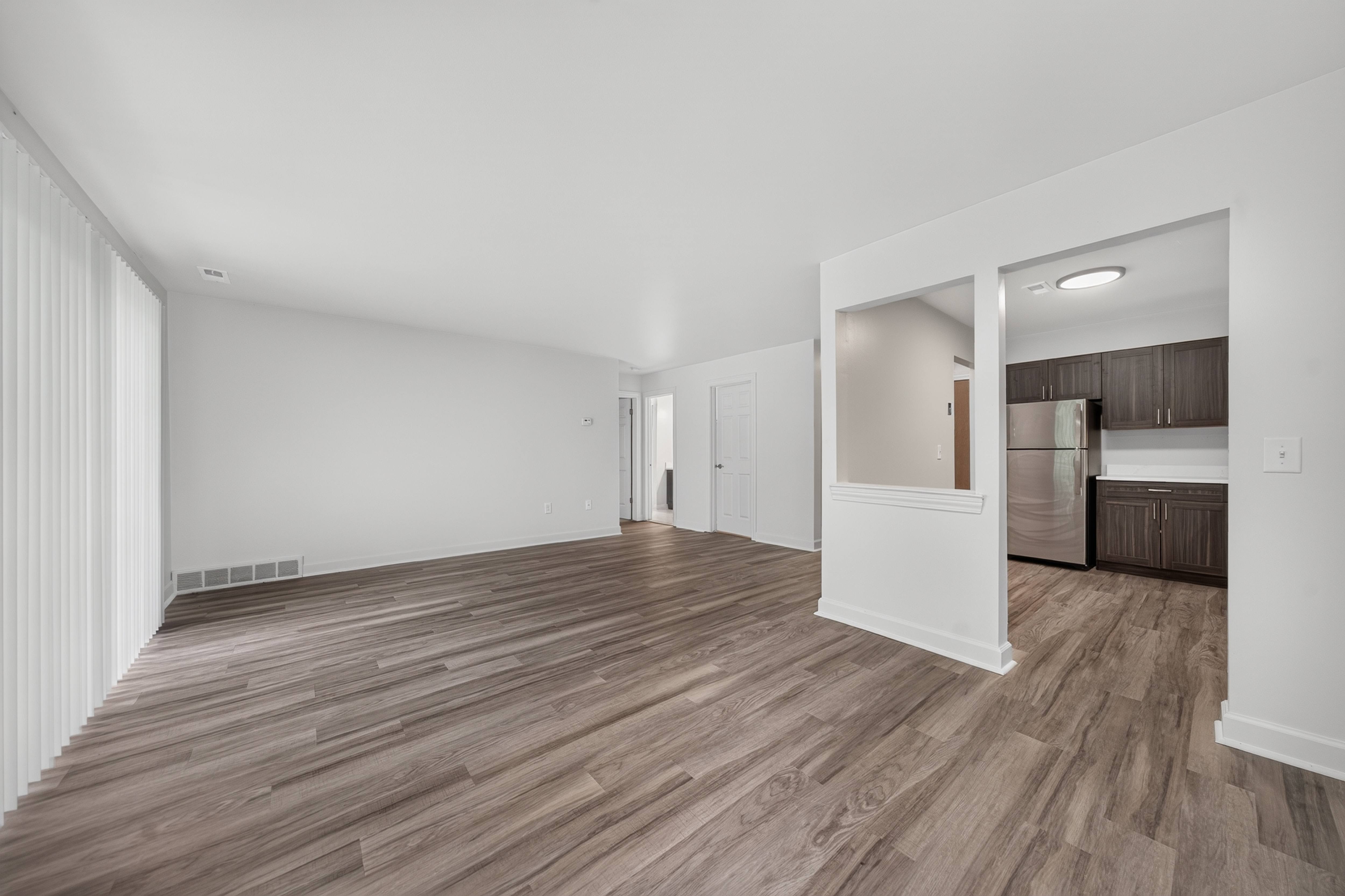 Open and airy living and dining room at Franklin River Apartments in Southfield, MI.