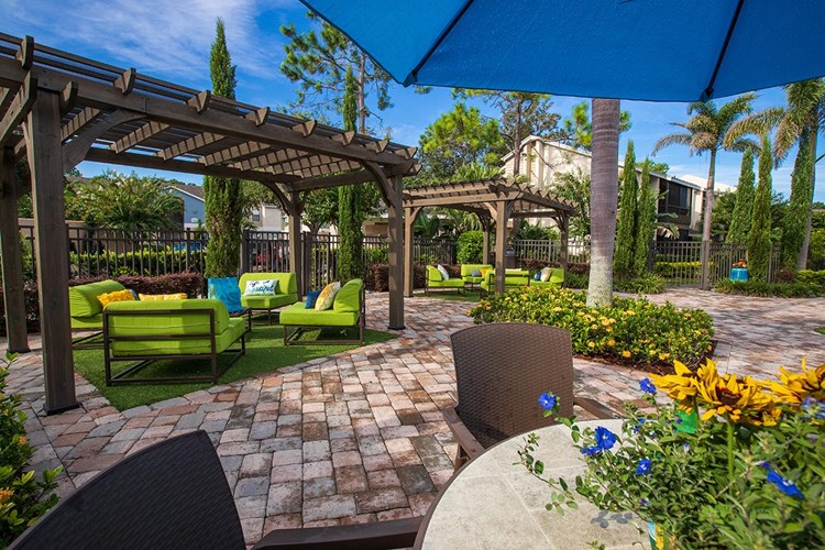 Sit at one of our poolside tables with umbrellas or under one of our pergolas.