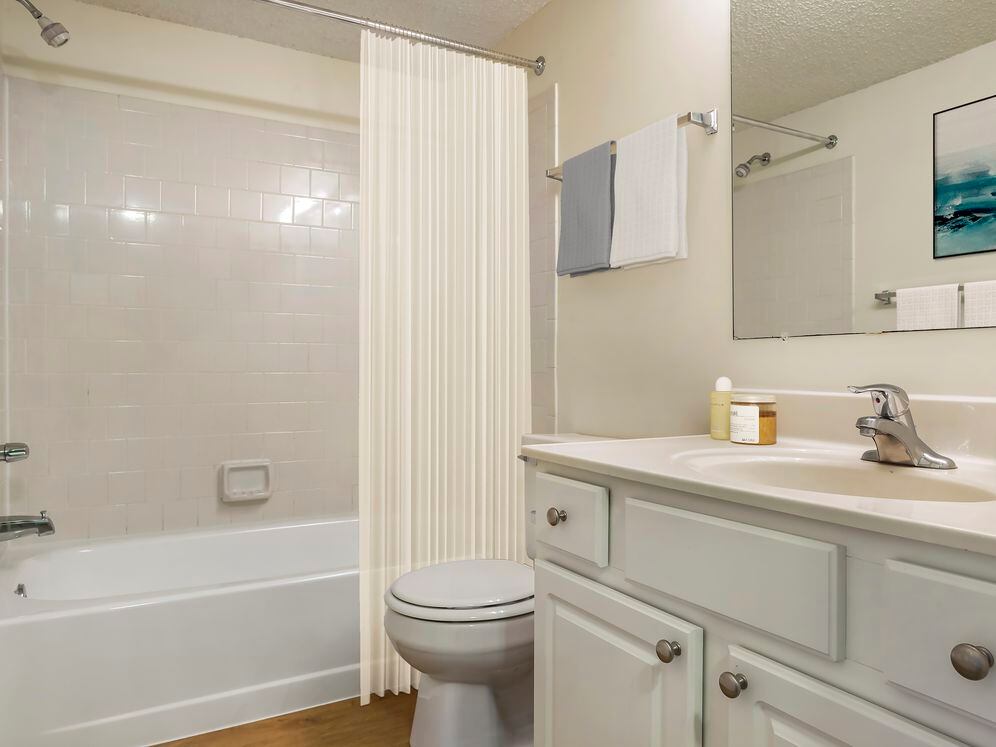 Upgraded Package I bath with white cabinetry, white countertop and hard surface flooring
