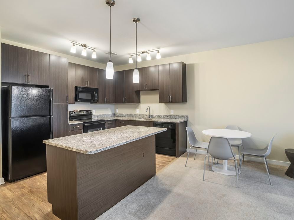 Furnished+ apartment homes include a dining set (Representative Image – exact items and style of furnishings may vary)