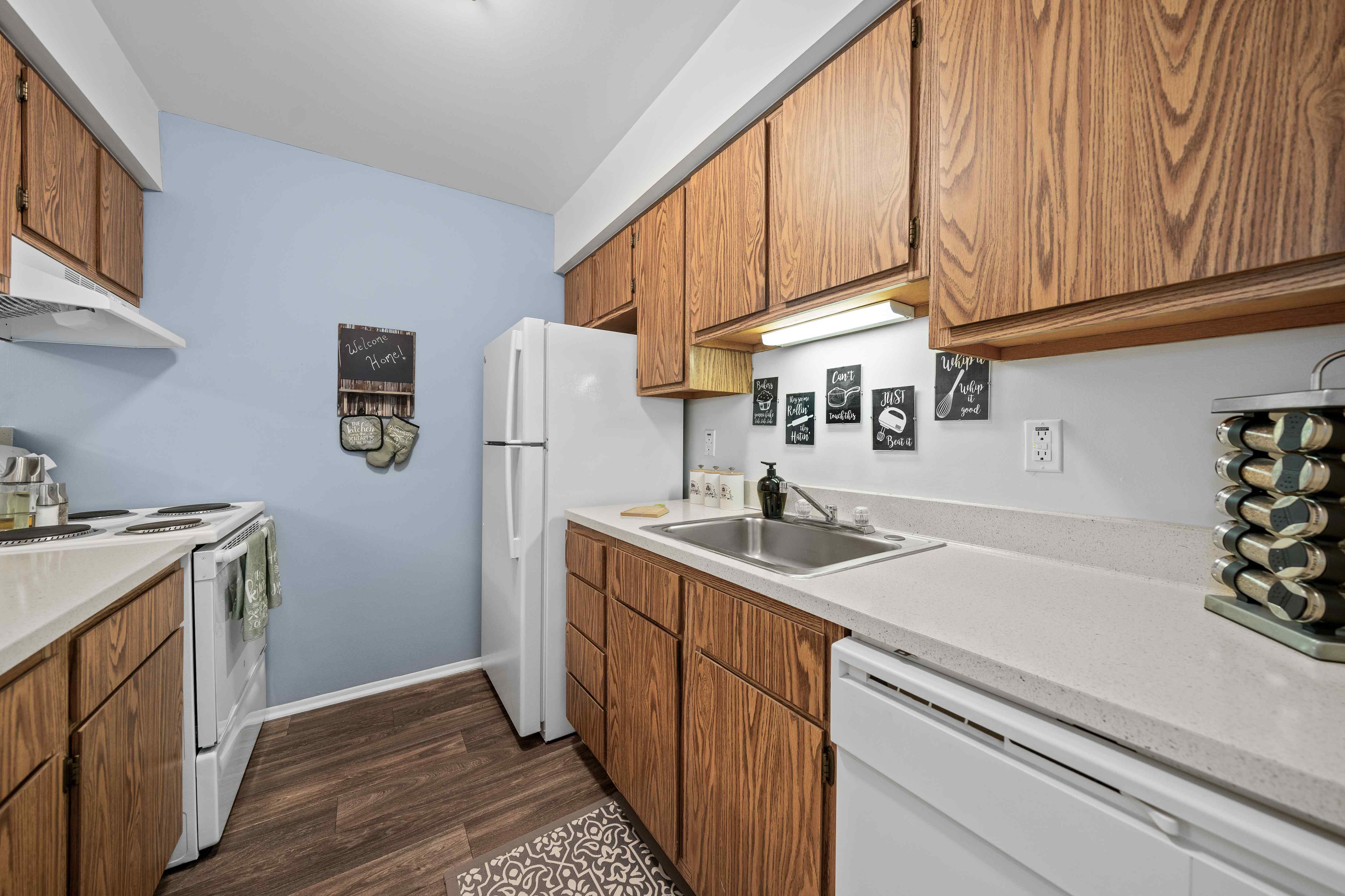 Efficient and cozy kitchen at Woodland Villa Apartments in Westland, MI.