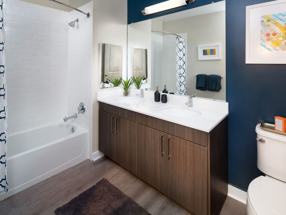 Avalon Package bath with espresso cabinetry, white quartz countertops and hard surface flooring