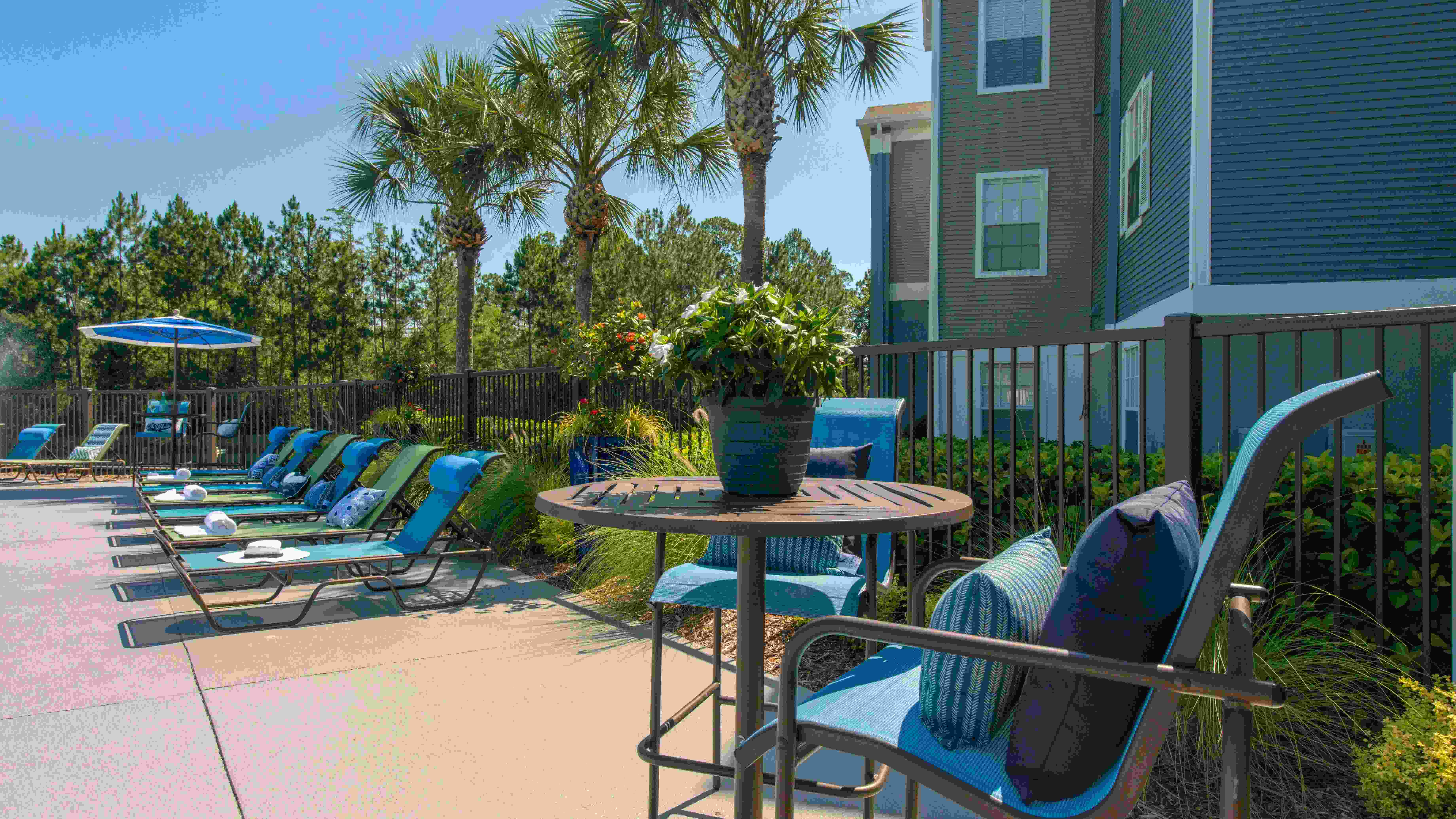 Relax in style with plentiful poolside tables and lounge seating.