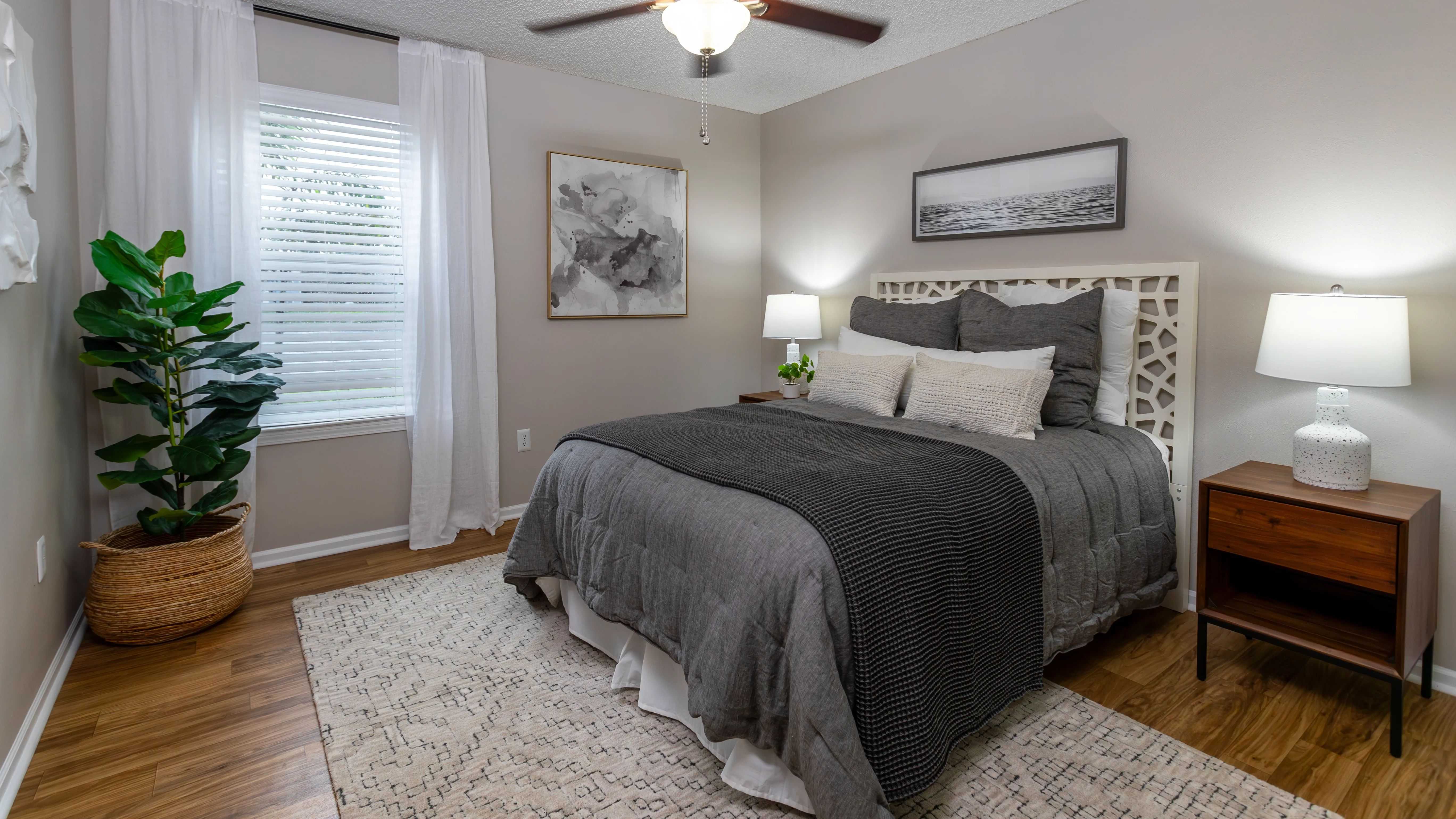 Our spacious bedrooms feature wood-style flooring, a multi-speed ceiling fan, and large windows bringing in natural light.