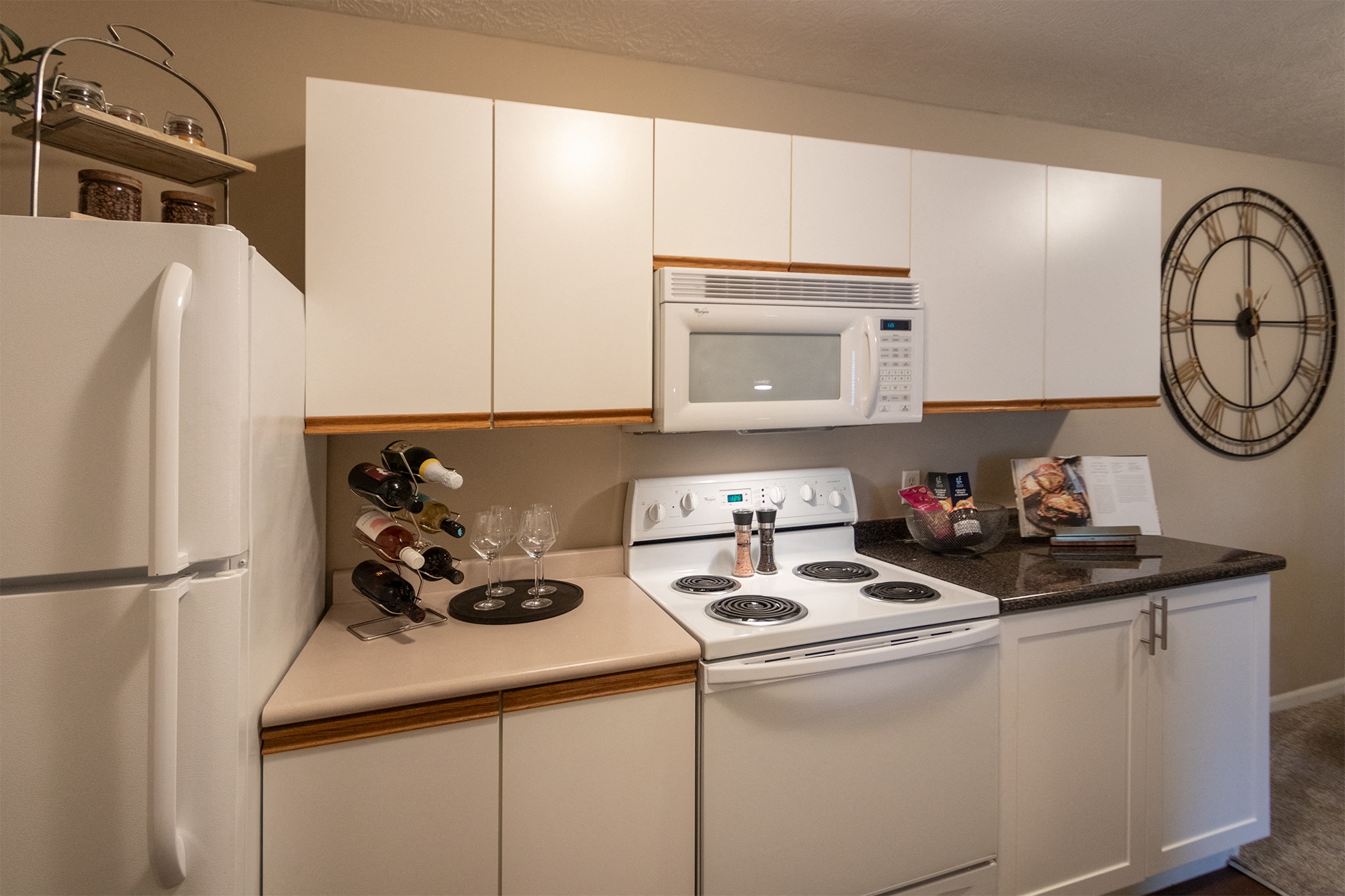 Our model Liberty kitchen features both upgraded cabinetry with dark countertops and classic cabinetry with light countertops.