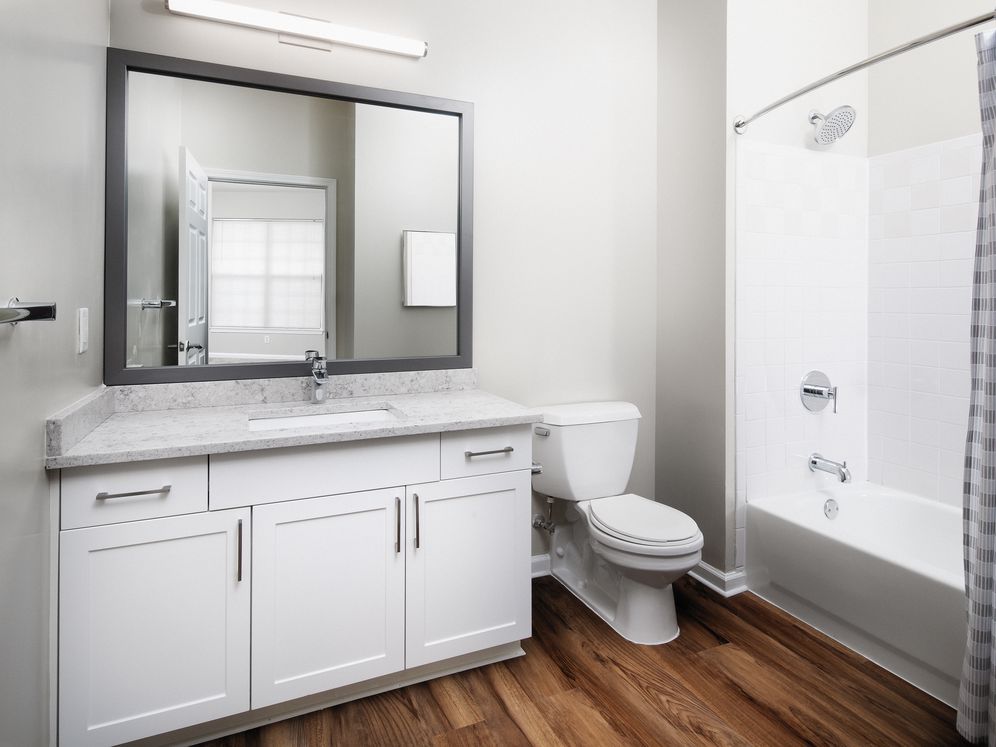 Classic Finish bath with white cabinetry, white quartz countertop, and hard surface flooring