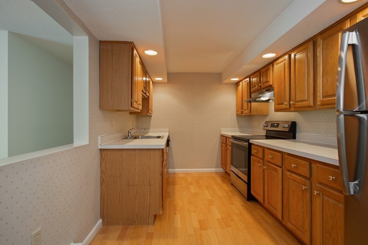 Spacious kitchens with wood flooring throughout