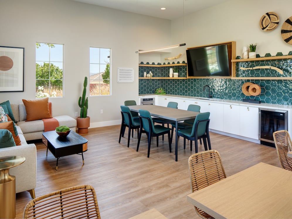 Resident lounge with entertaining kitchen, dining area, and lounge seating