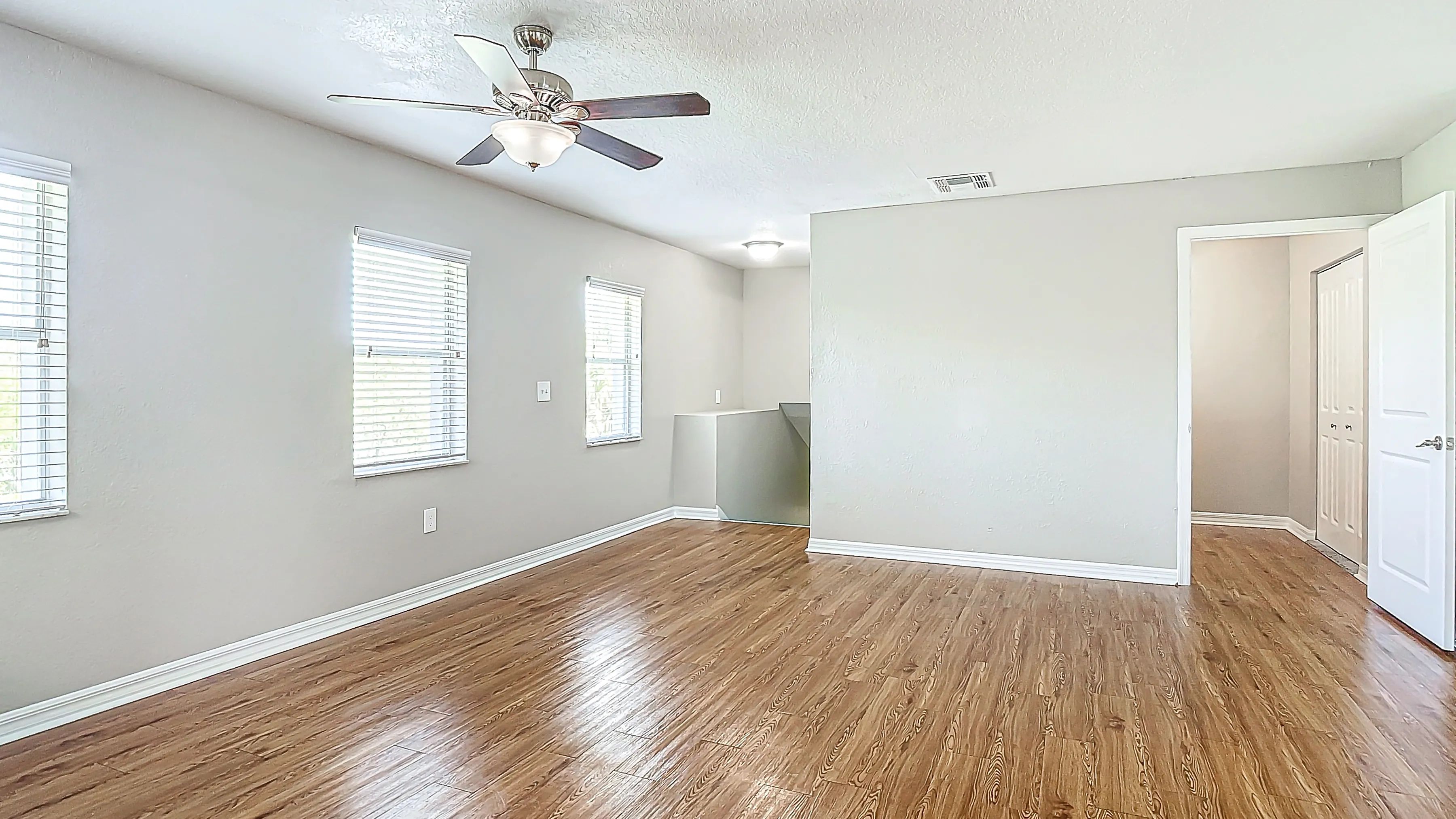 Enjoy a bright and spacious living area with wood-style flooring and ample natural light.