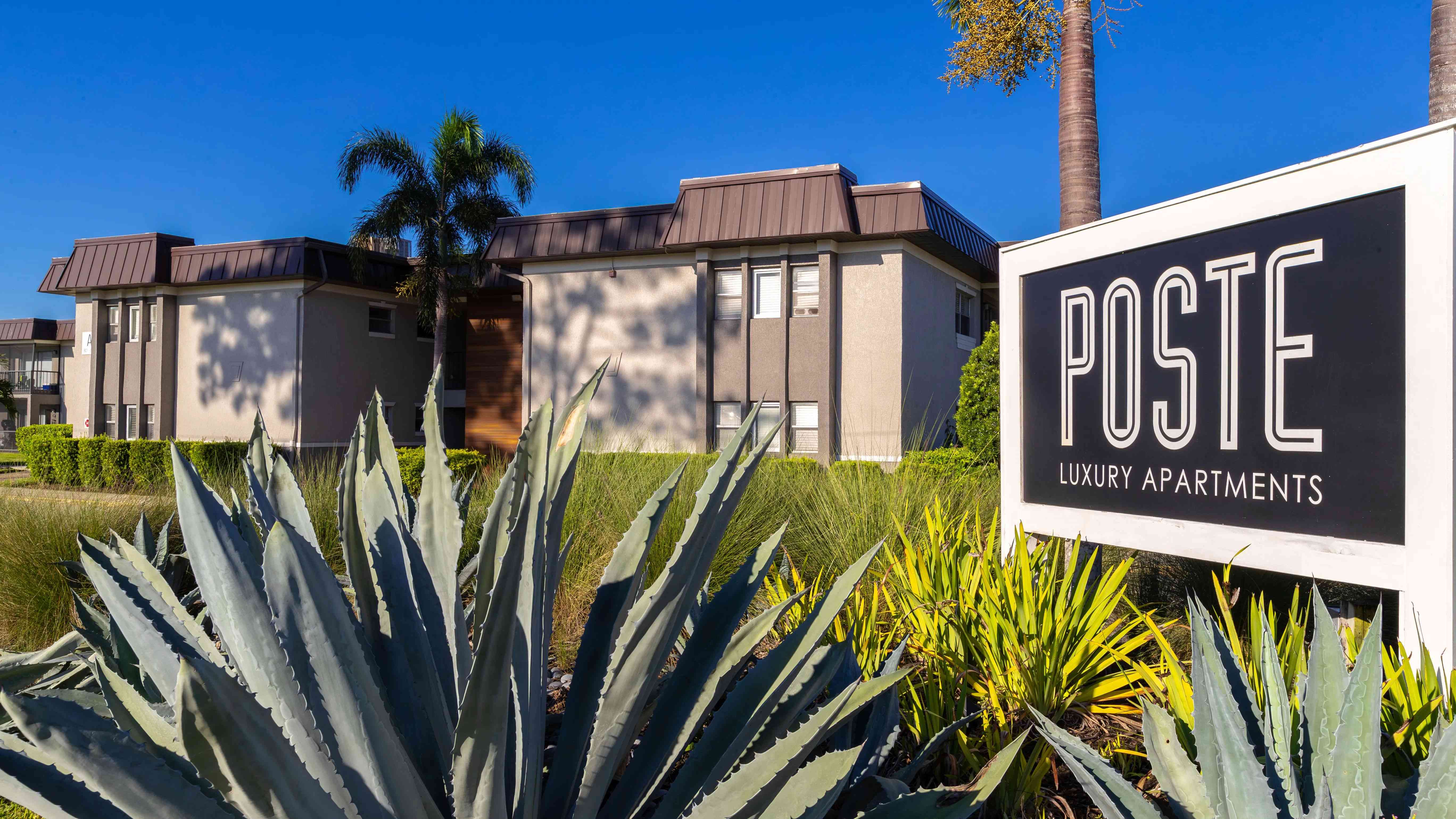 Experience upscale living at Poste Luxury Apartments. Surrounded by lush landscaping and modern design, our community offers a blend of comfort and sophistication in a serene environment.