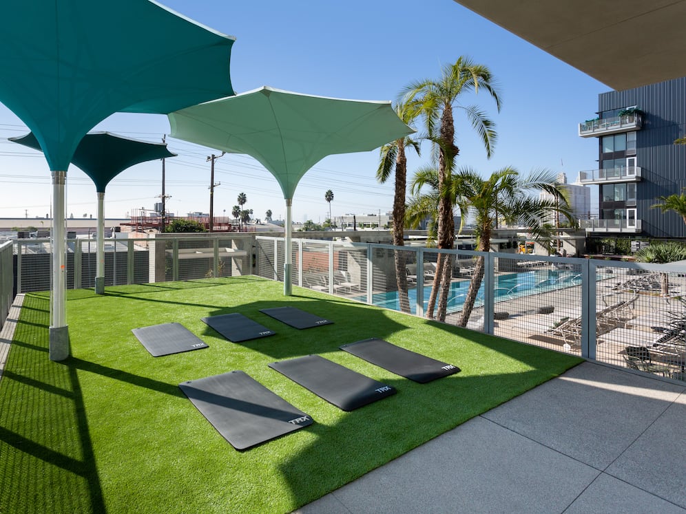 Outdoor yoga deck overlooking pool