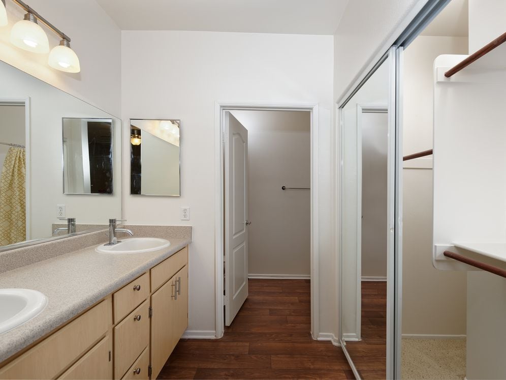 Bath with laminate countertops, oak cabinetry, and hard surface flooring