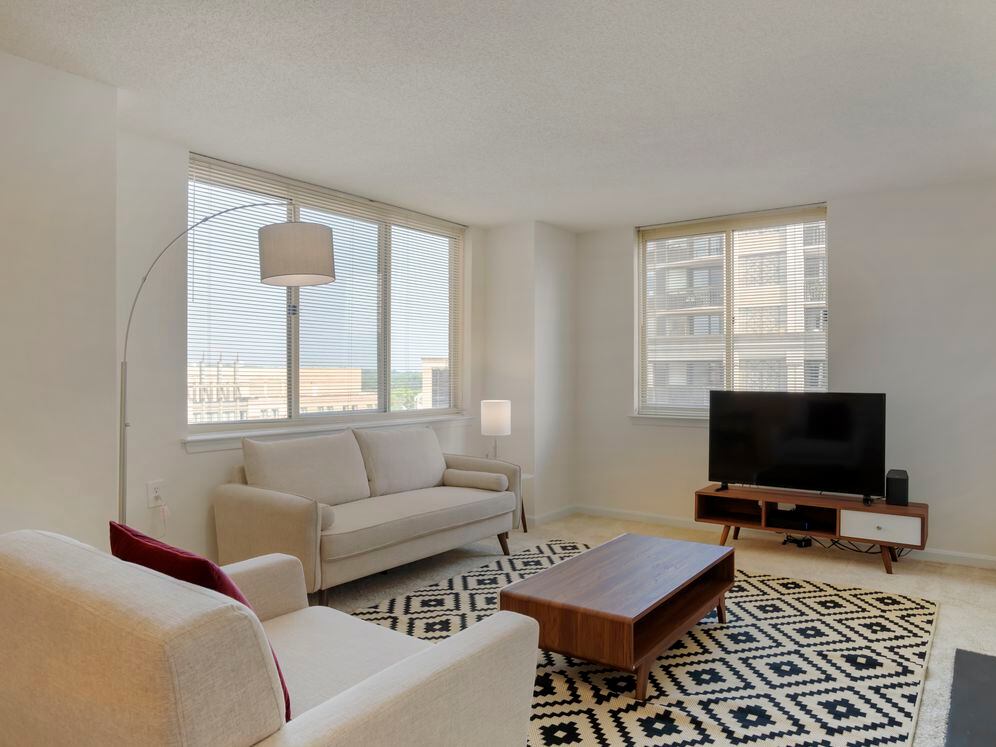 Furnished+ apartment homes come outfitted with a sofa, side chair, side table, coffee table, TV stand and 50" Television (Representative Image – exact items and style of furnishings may vary)