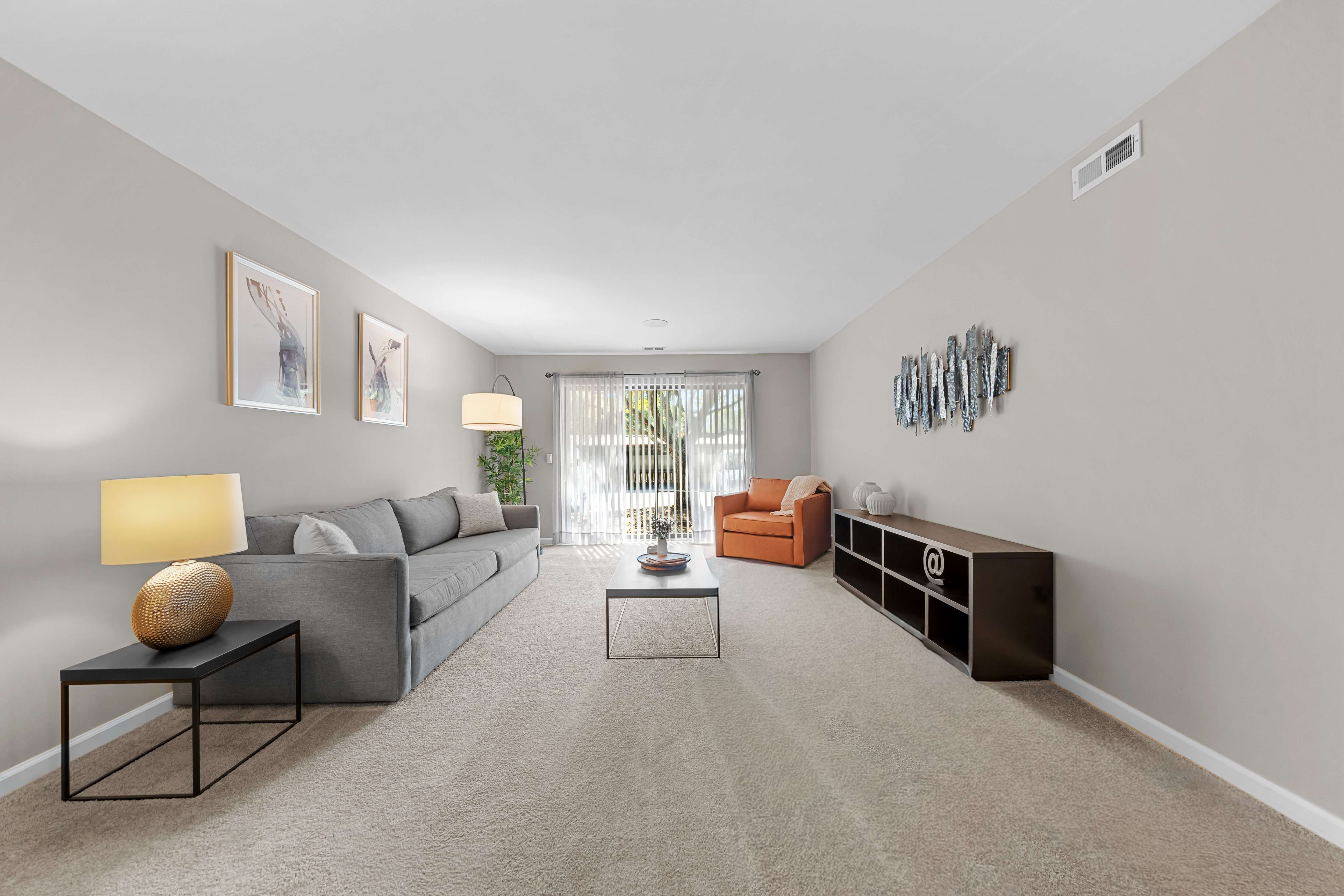 Spacious Living Room with Sliding Glass Door at Lakeside Village Apartments Clinton Township MI