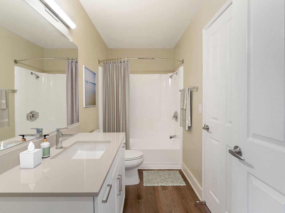 Renovated Package I bath with beige granite countertops, white cabinetry, and hard surface flooring