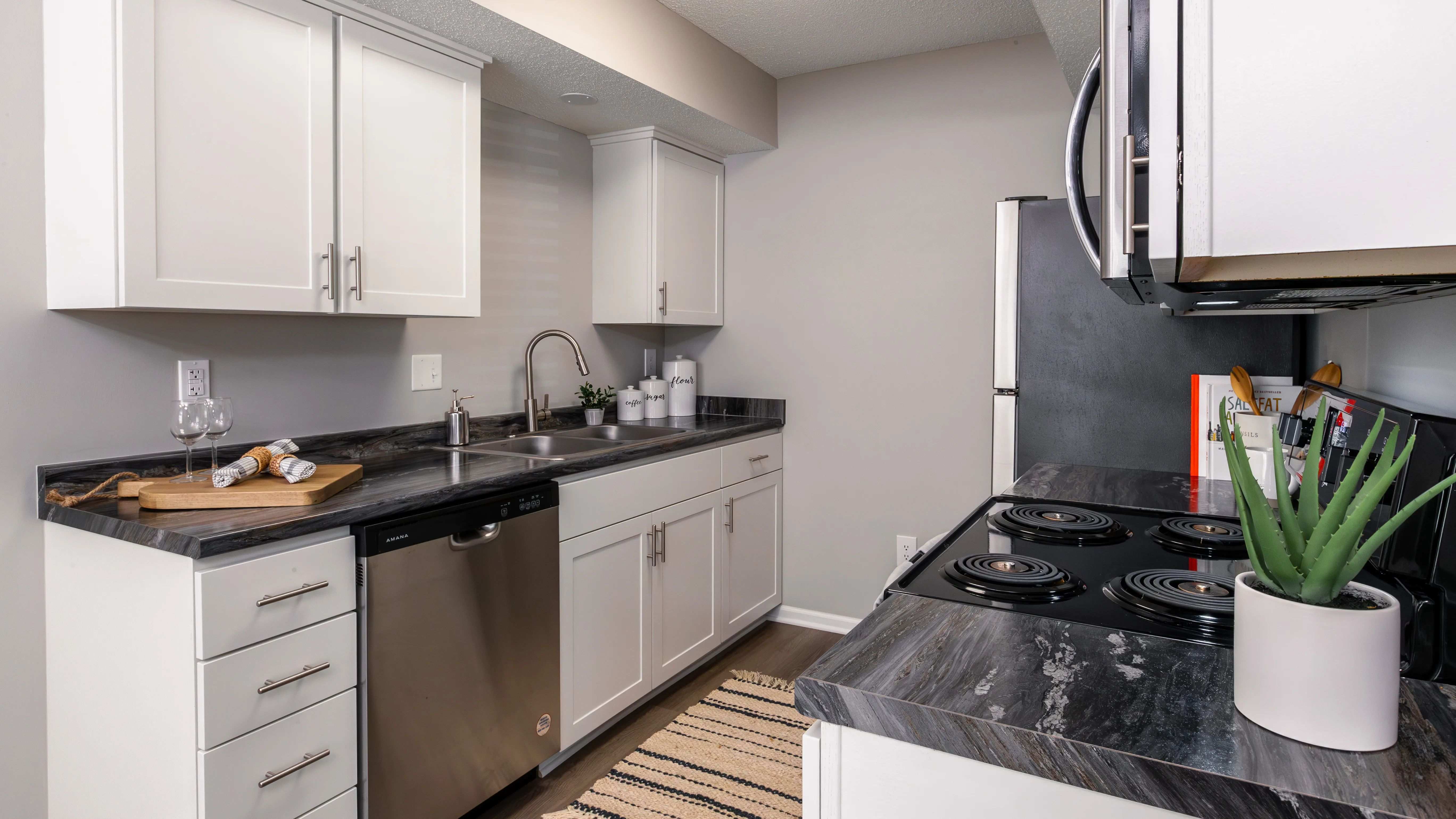 A sleek and modern kitchen featuring stainless steel appliances, ample storage, and elegant countertops.