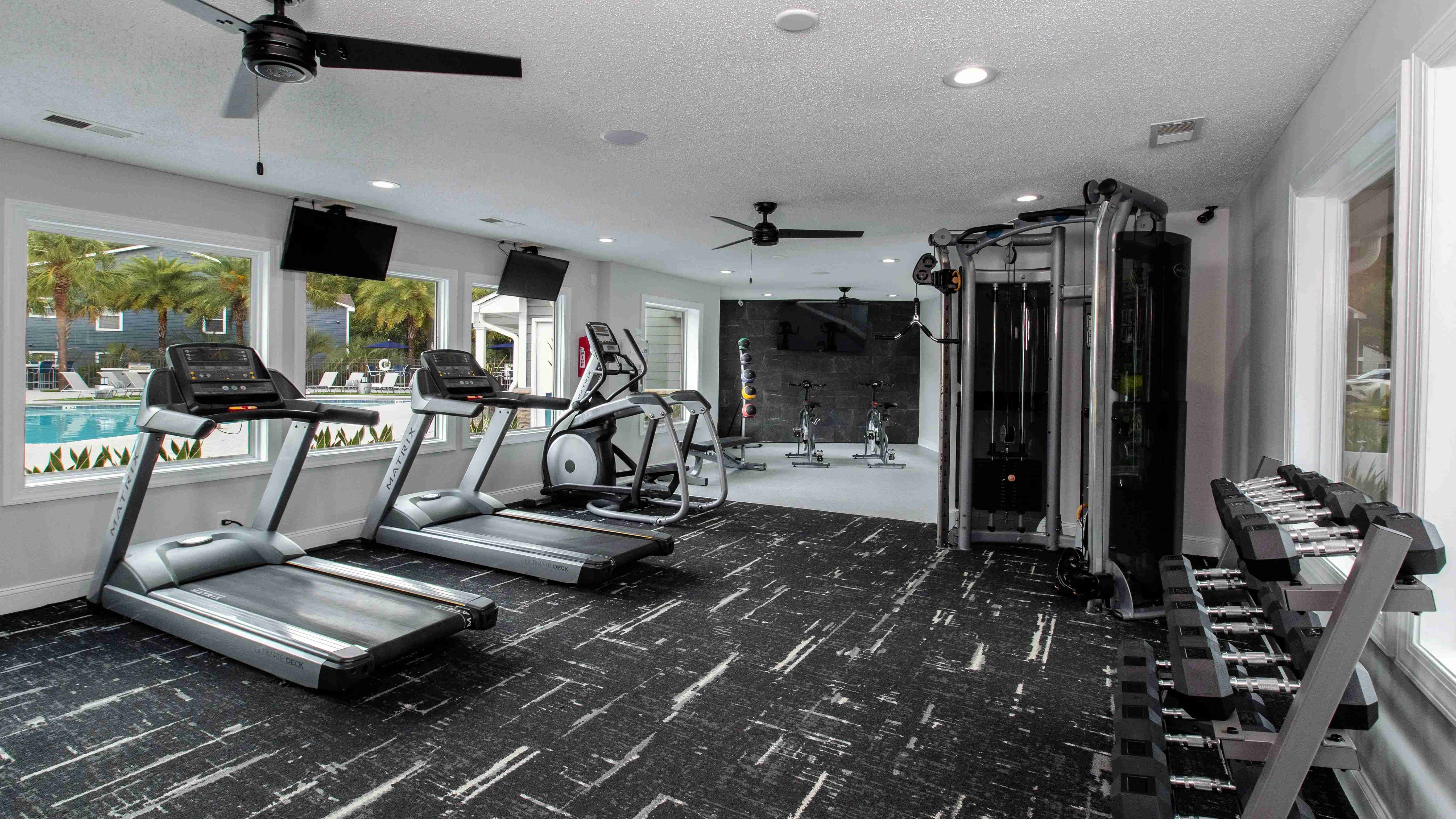 Welcome to our expansive fitness center at Emerson Isles, your round-the-clock wellness destination. From versatile weight machines to spin bikes, treadmills, free weights, and more, we've got all the tools for a comprehensive workout. 