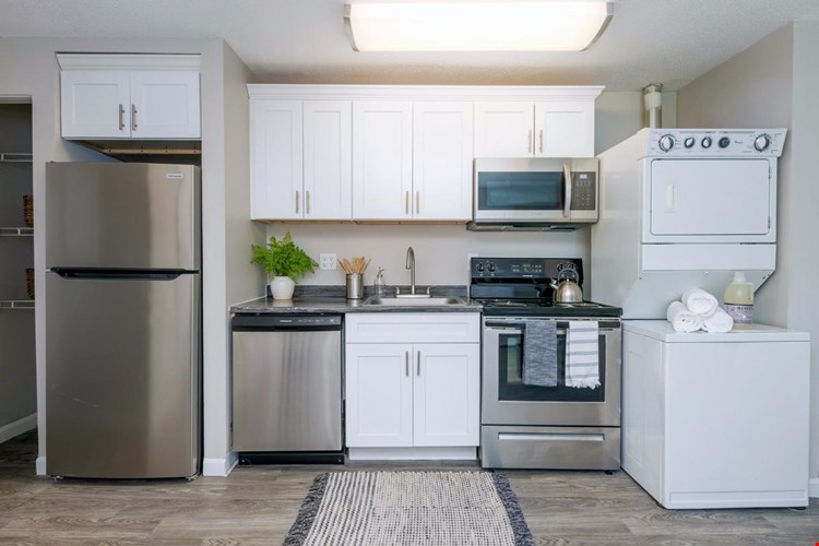 Kitchens feature stainless steel appliances and ample cabinetry.