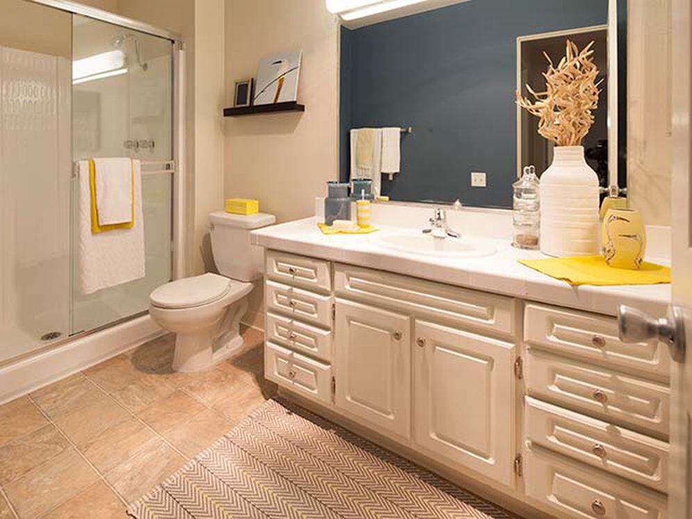 Classic Package I bath with white tile countertop, white cabinetry, and vinyl tile flooring